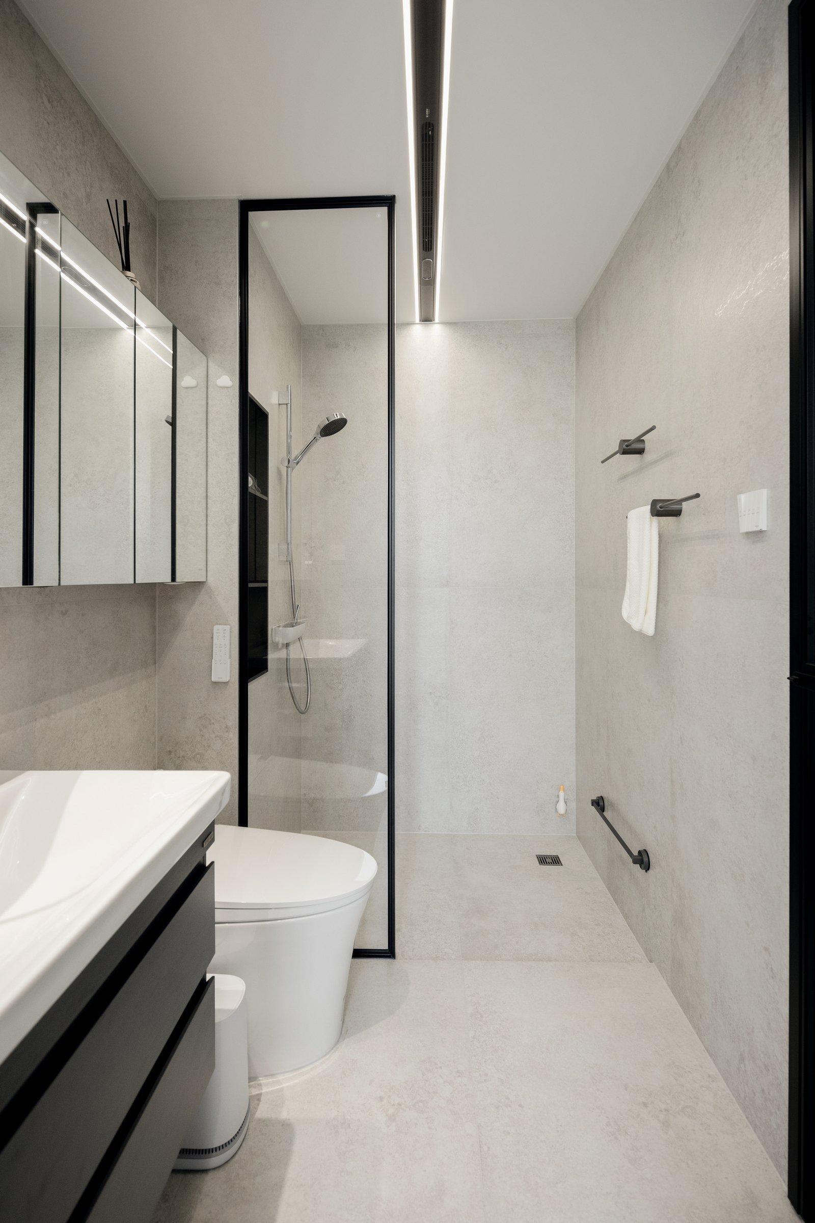 Completed bathroom with integrated vanity and restrained material palette