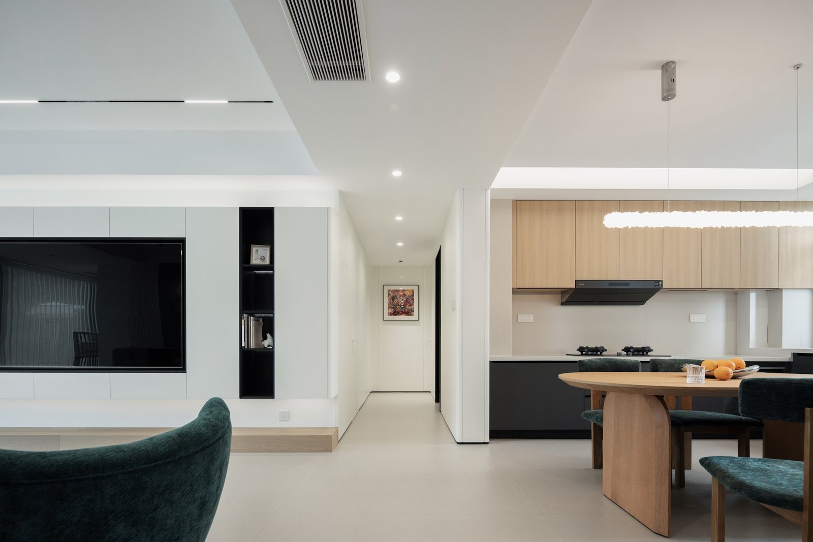 Open-plan living and dining area with integrated television wall