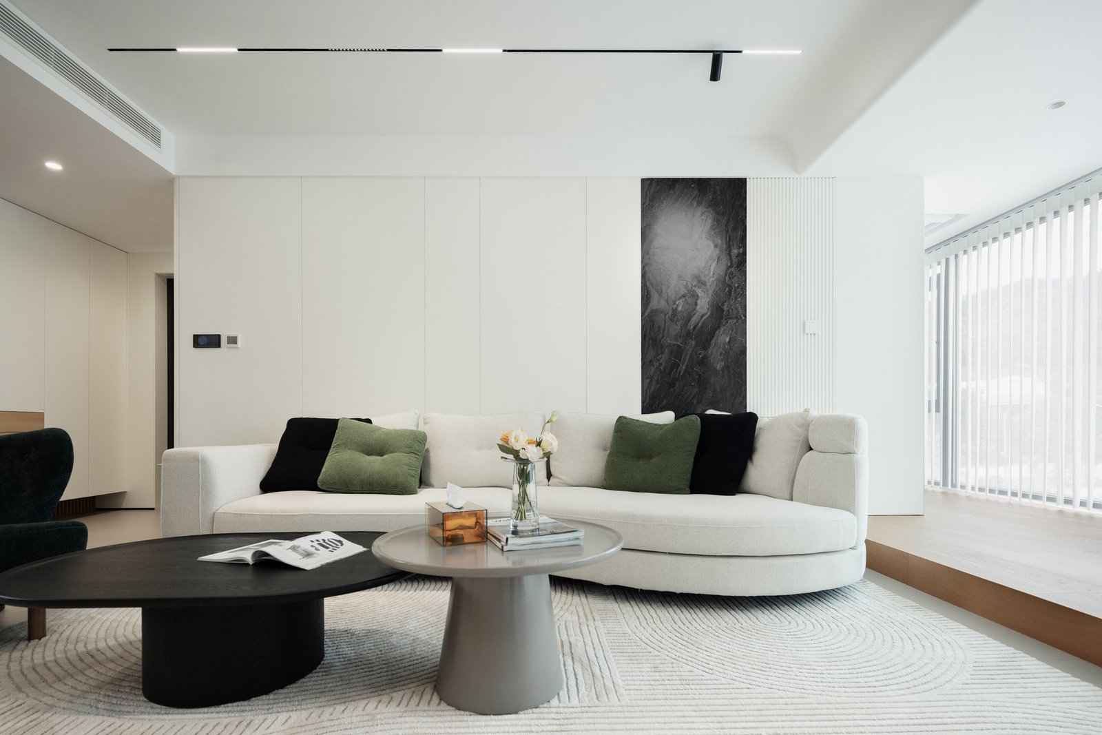 Front view of the completed living room with deep green seating