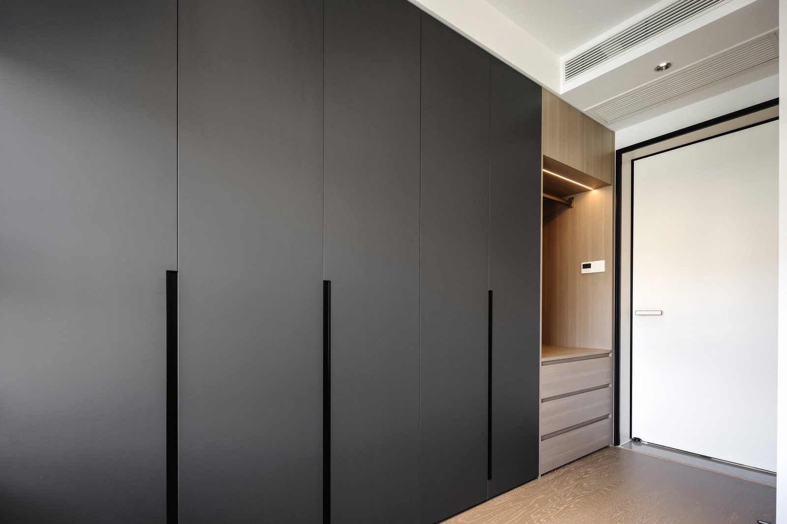 Full-height storage cabinetry near the entrance