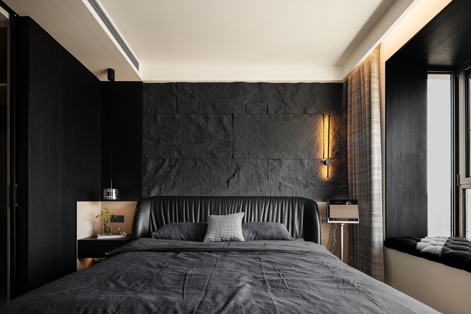Completed primary bedroom with dark textured wall