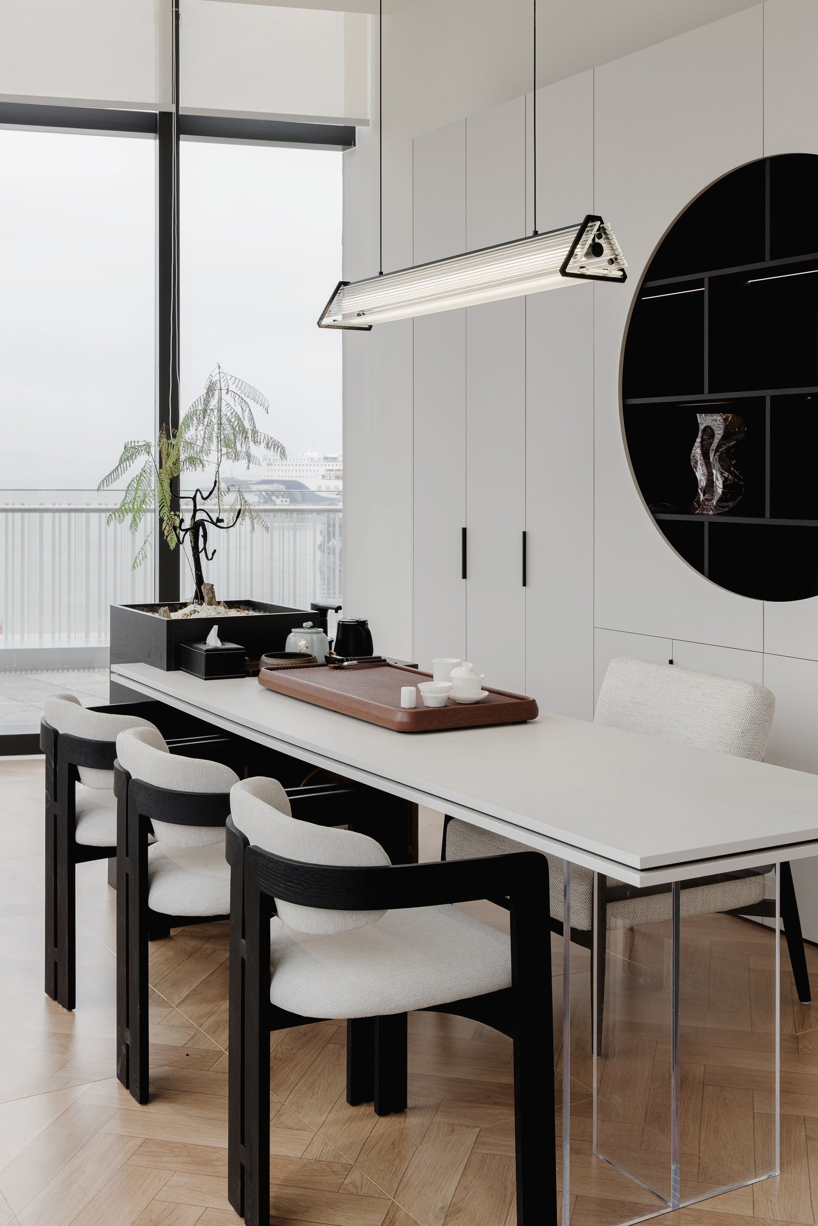 Detail of the consultation space with white cabinetry and dark accents